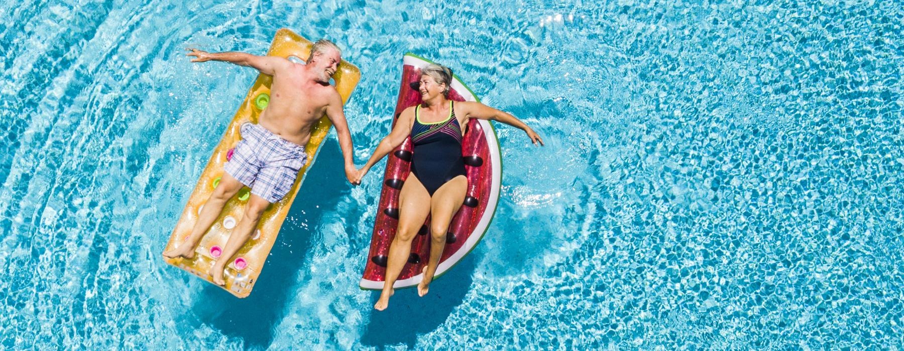 a couple of people in swimsuits in the water