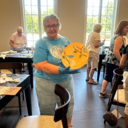 a person holding a piece of art